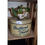 A Brittons Fine Foods Potato Crisps tin and a Chinese teapot