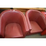 A pair of red faux leather tub chairs