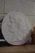 A plaster relief panel of a maiden with vines in her hair