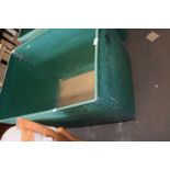 A green plastic and plywood vintage laundry bin on casters