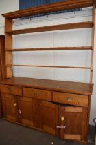 Pine kitchen dresser with cupboards, drawers and shelving above