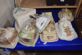 A quantity of cheese dishes and covers