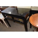 A Chinese style black painted side table