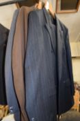 A gents Marks & Spencer navy blue pin striped suit and two others