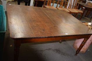 An oak extending dining table on turned legs