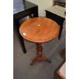 A round side table on turned base with paw feet