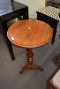 A round side table on turned base with paw feet
