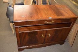 A drinks cabinet with lift up lid and cupboards below