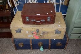 A group of three vintage suitcases