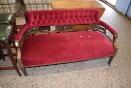 An Edwardian bow back sofa with buttoned upholstery