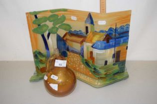 An Art Glass panel decorated with a village street scene together with an Art Glass model of a pear