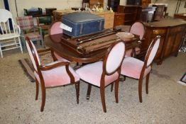 A reproduction mahogany pedestal dining table and six accompanying pink upholstered chairs (7)