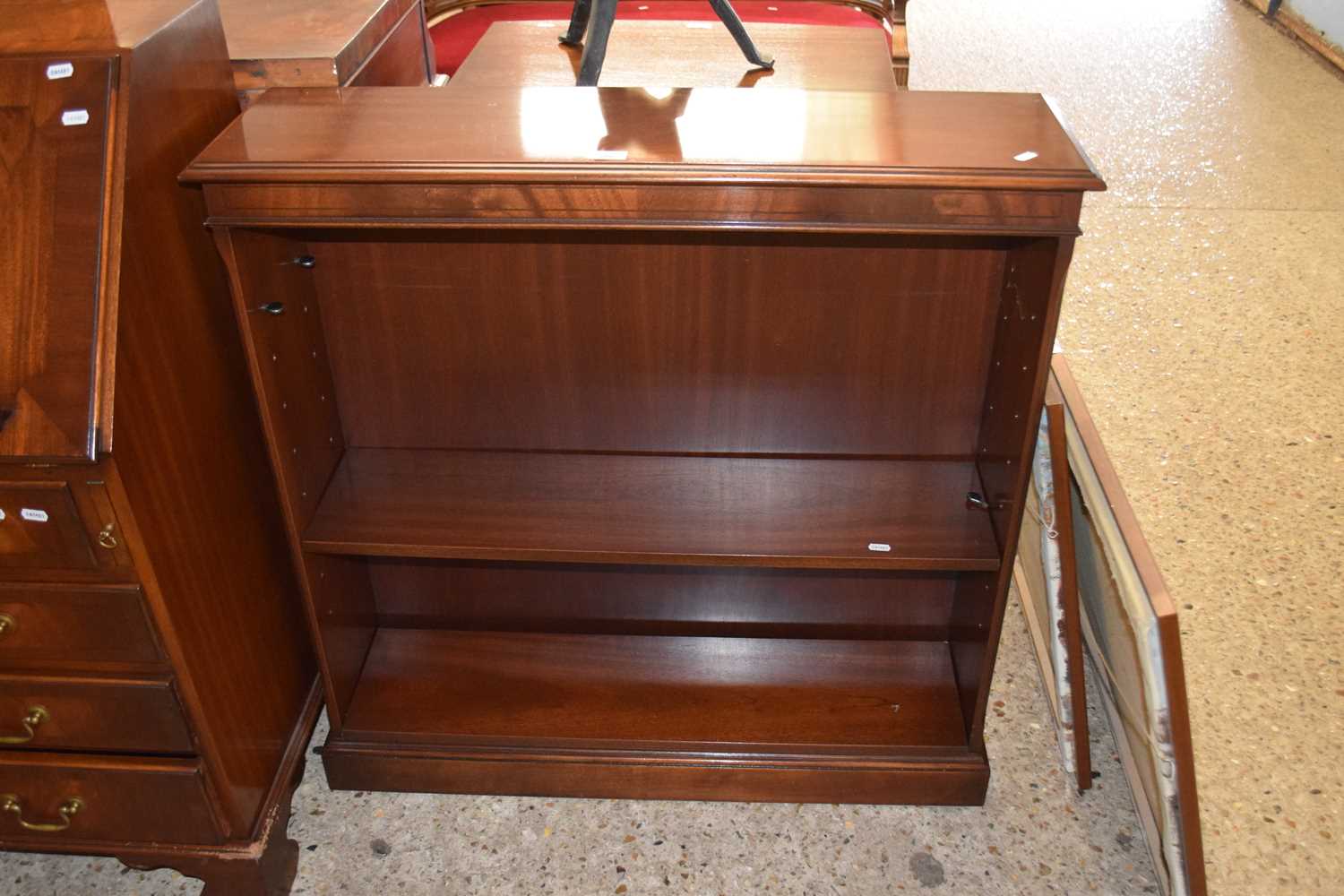 A reproduction mahogany open front bookcase cabinet