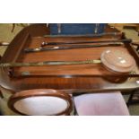 A copper bed warming pan