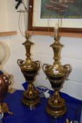 A pair of modern table lamps with brass vase formed bodies and circular plinth bases