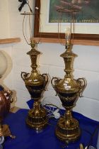 A pair of modern table lamps with brass vase formed bodies and circular plinth bases