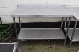 A steel kitchen preparation table, 125cm wide