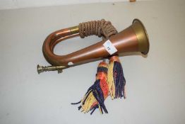 A copper and brass bugle with tassel decoration, unmarked