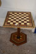 A contemporary pedestal chess table