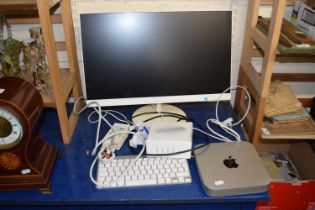 An Apple Mac Mini together with a Philips flat screen keyboad and a wireless mouse