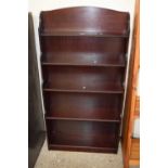 A reproduction mahogany effect waterfall bookcase