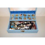 A blue case of various costume jewellery