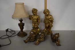 Group of various cherub models and a table lamp