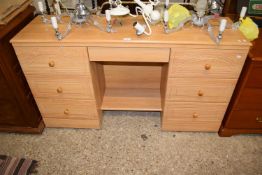 A light wood effect twin pedestal dressing table