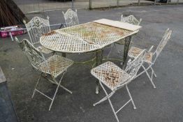 Cream painted metal mesh top garden table and six accompanying chairs