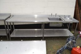 A steel kitchen preparation table with sink and basin, 250cm wide
