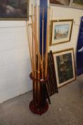 A Riley snooker scorer together with a cue stand and various assorted cues