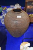 A large contemporary pottery vase with ribbed decoration