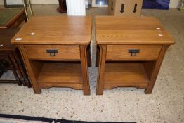 A pair of modern oak bedside cabinets