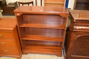 A reproduction mahogany veneered open front bookcase cabinet