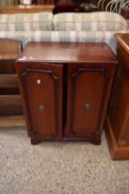 A small mahogany two door bookcase cabinet