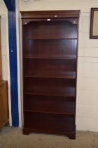 A mahogany finish open front bookcase cabinet