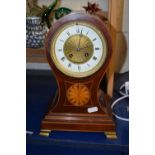 An Edwardian mantel clock in balloon type mahogany case