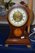 An Edwardian mantel clock in balloon type mahogany case