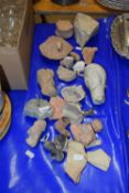 A collection of various ancient Cypriot pottery fragments and other items