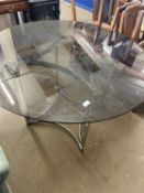 A smoked glass top aluminium framed round dining table