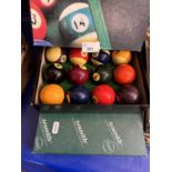 Two boxes of pool and snooker balls