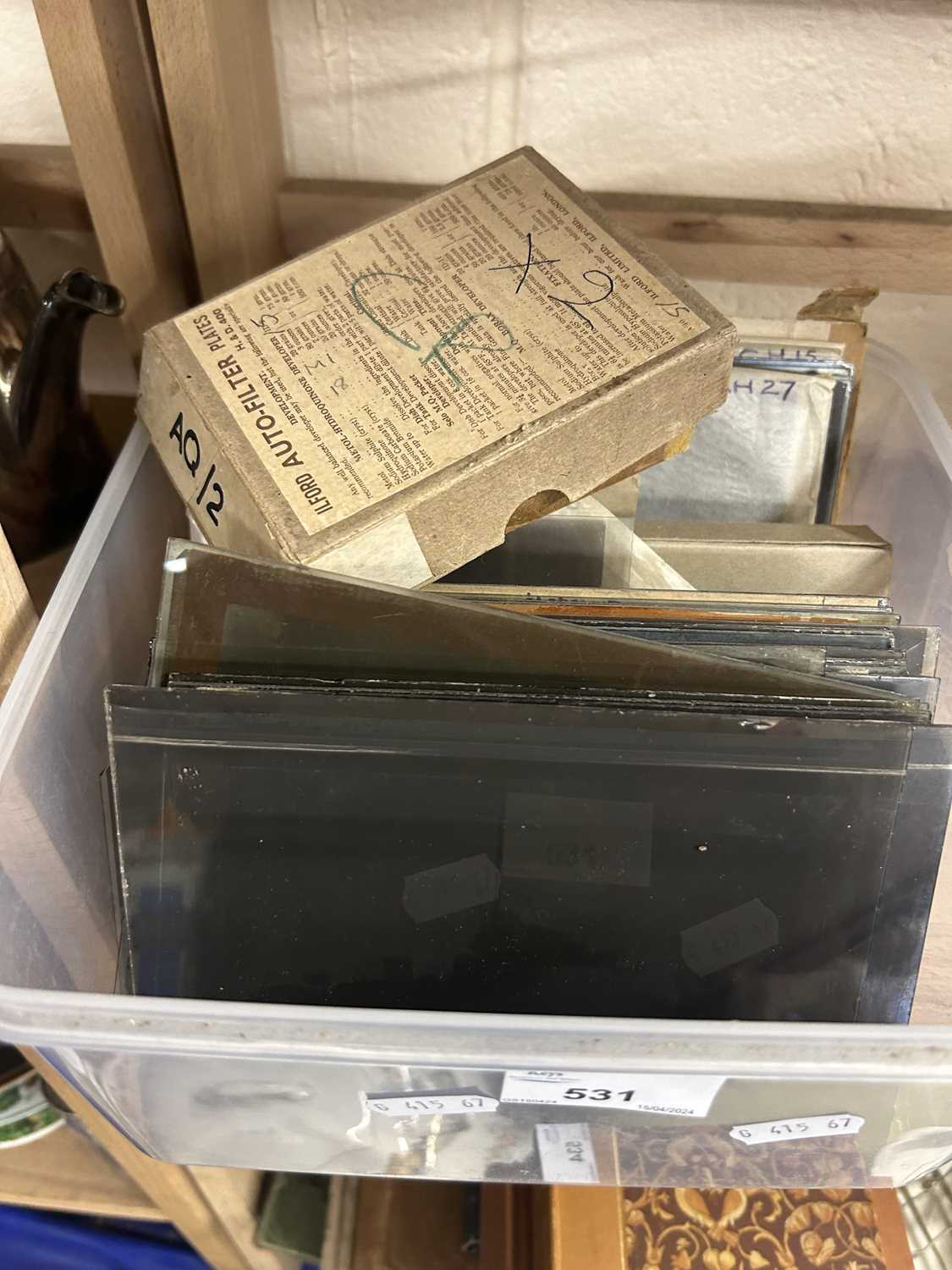 A box of various glass photographic slides