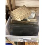 A box of various glass photographic slides