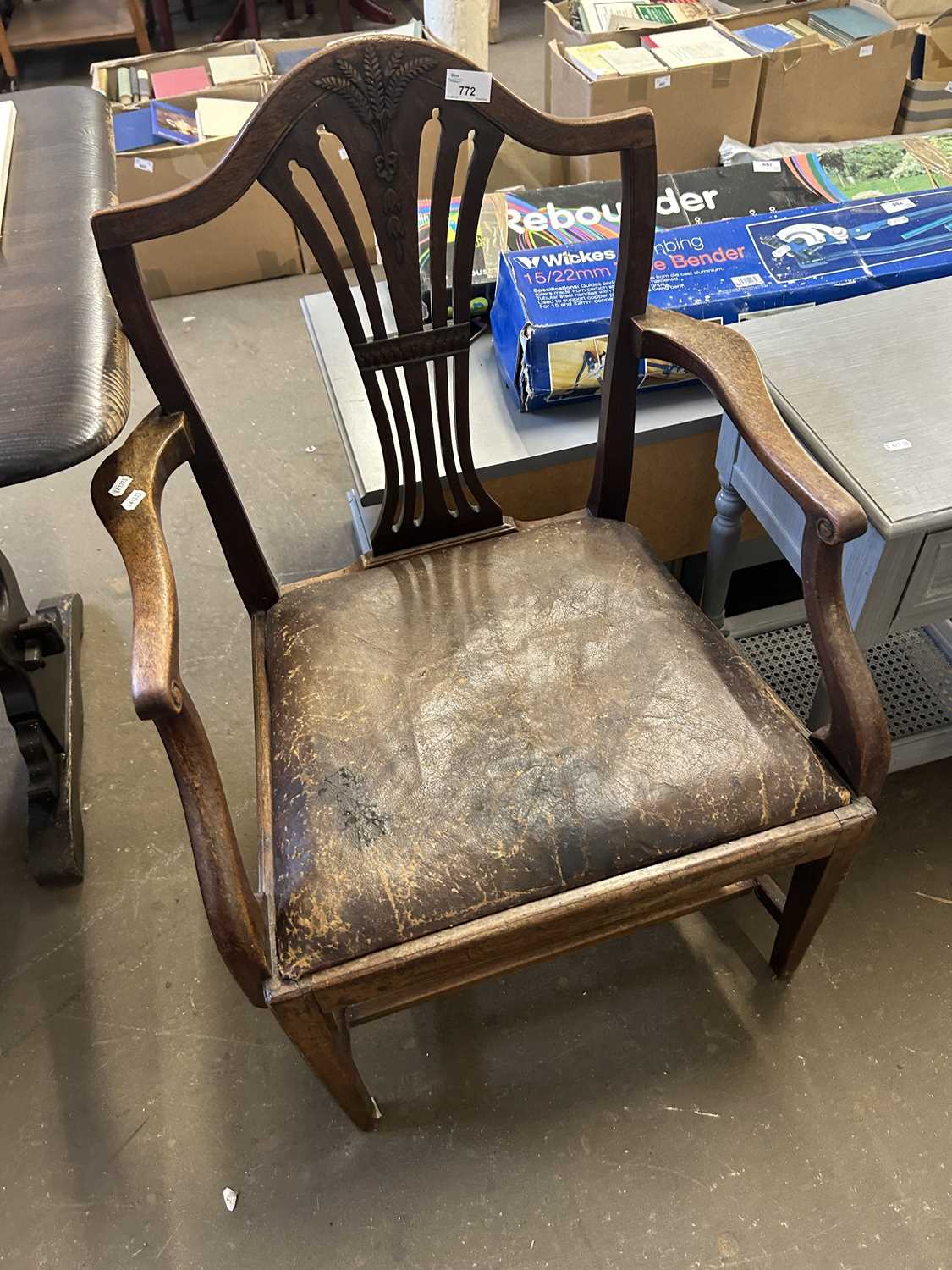 A mahogany elbow chair with drop in seat