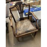 A mahogany elbow chair with drop in seat