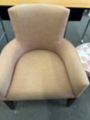 An orange upholstered single chair