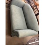 A green two seater sofa