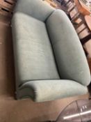 A green two seater sofa