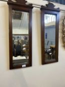 A pair of stained pine framed wall mirrors