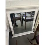 A cream painted wall mirror